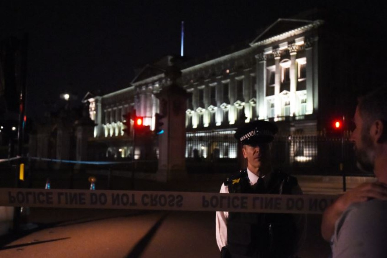A policeman stands guard at the taped-off scene of the attack outside Buckingham Palace.