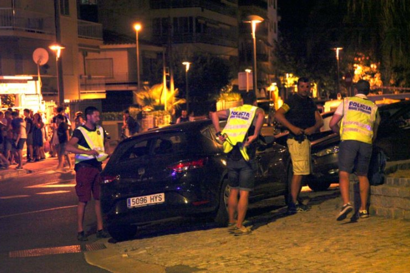 Spanish police surround a car after the shootout in the resort city of Cambils.