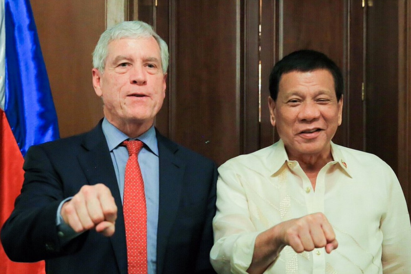 ASIS boss Tim Warner poses alongside Indonesian President Rodrigo Duterte.   
