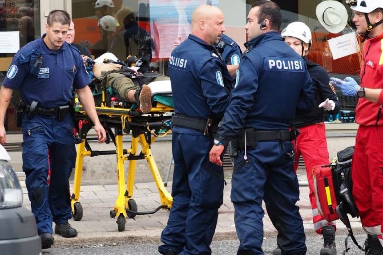 Finnish police and paramedics ferry the wounded to hospital after the knife rampage in Turku.