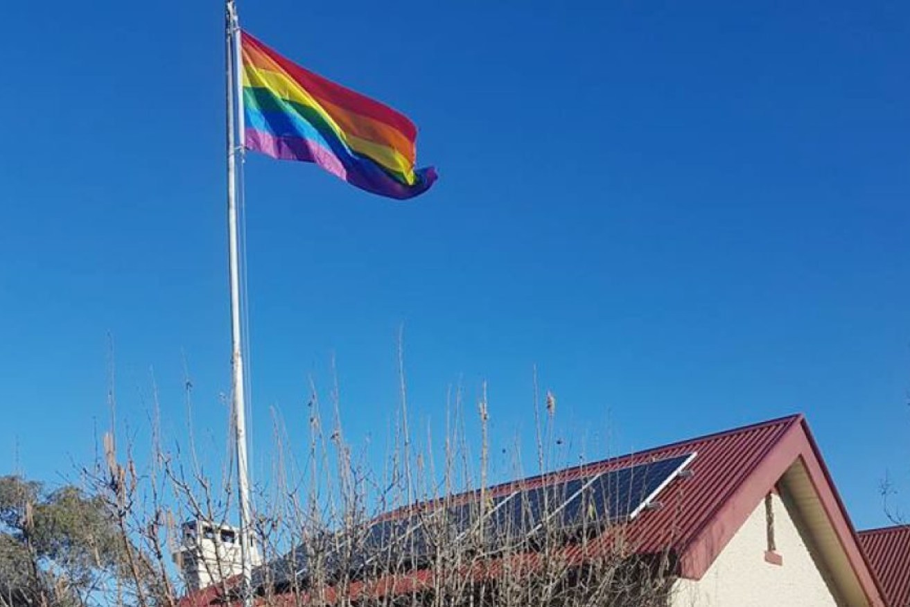 The post office licensee has been forced to remove the flag in the lead-up to a postal vote on same-sex marriage in Australia.