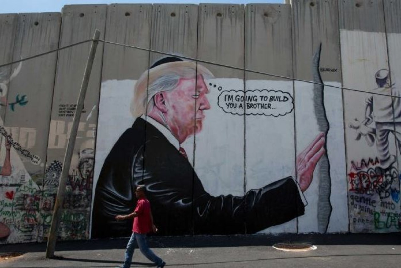 The mysterious Lushsux has taken his art - and  political commentary - from Australia to Israel with this pointed shot at Donald Trump's love of walls.