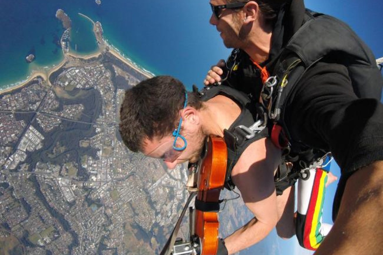 Glen Donnelly plays the violin while naked skydiving.