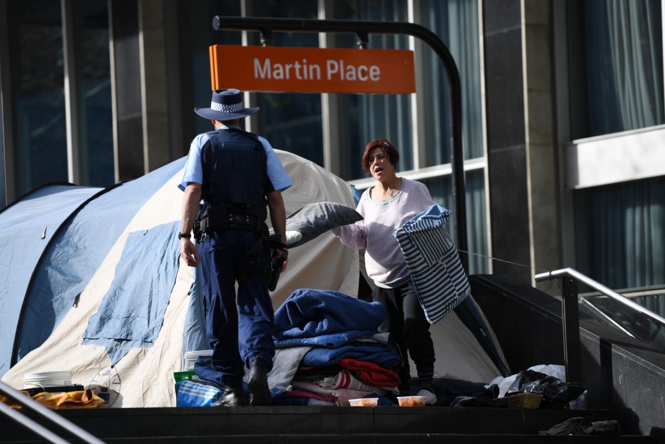 A Tent City resident talks to police as she prepares to find other accommodation. Photo: AAP