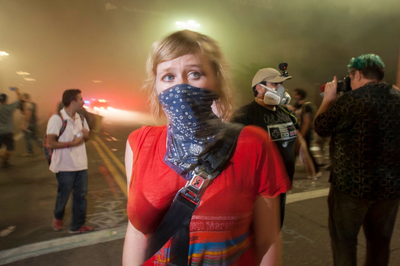 Police use tear gas to break up protesters gathered outside of the Phoenix, Arizona.