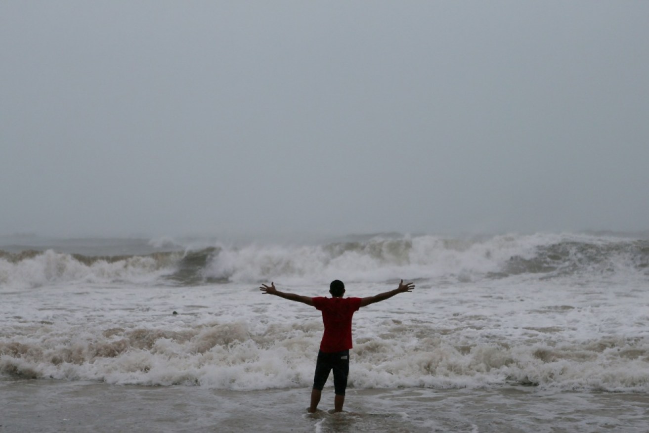 A man stands on a beach in Puerto Rico before Hurricane Irma hits.