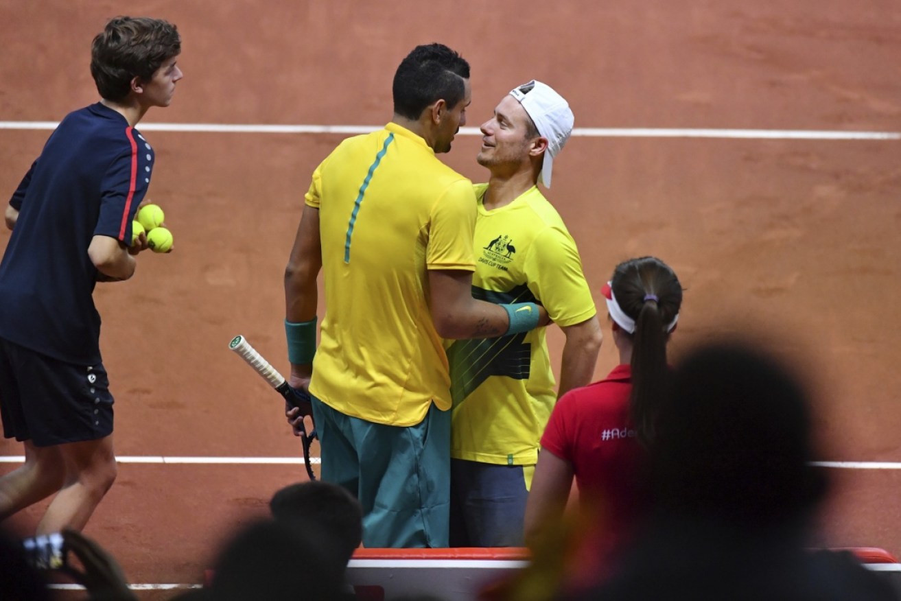 Team captain Lleyton Hewitt congratulates Kyrgios after sealing one of his best victories in an Australian shirt.
