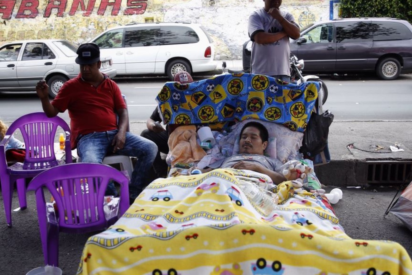 This Mexico City resident takes the ongoing aftershocks in his stride, tucked up in bed on a busy street.