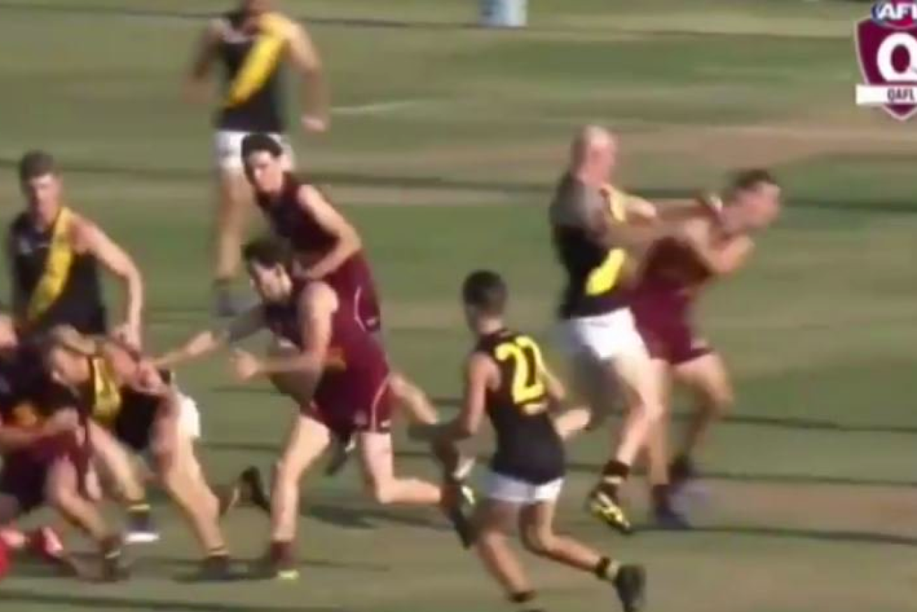 Barry Hall was captured punching one of his opponents during the QAFL grand final.