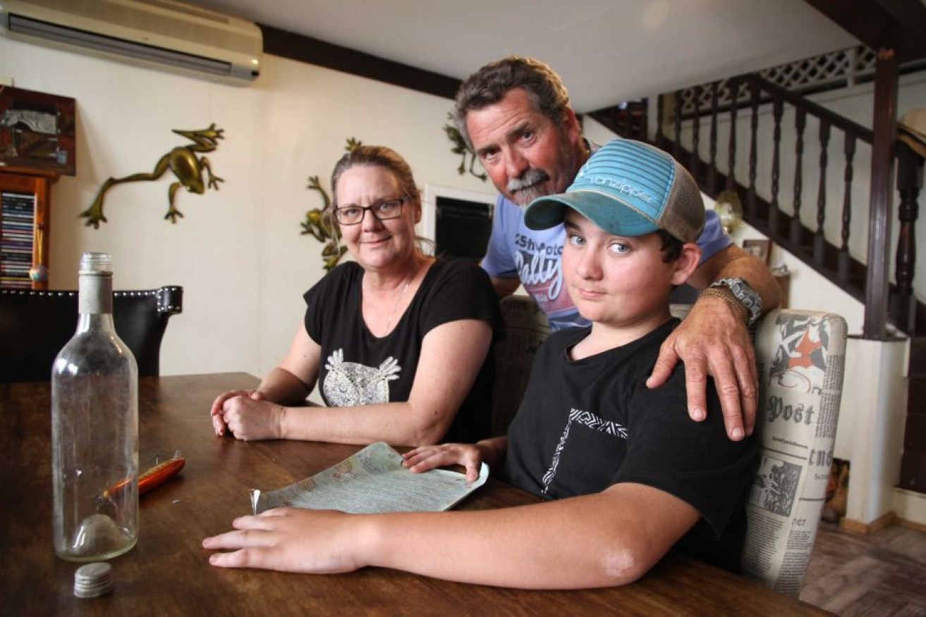 Bailey, with parents Fiona Knox and Lloyd Baker found a message in a bottle with a difference while fishing.