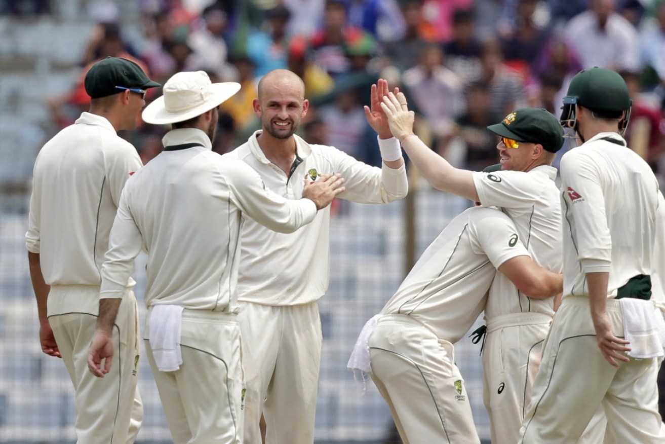 Nathan Lyon (centre) took seven wickets in the first innings.