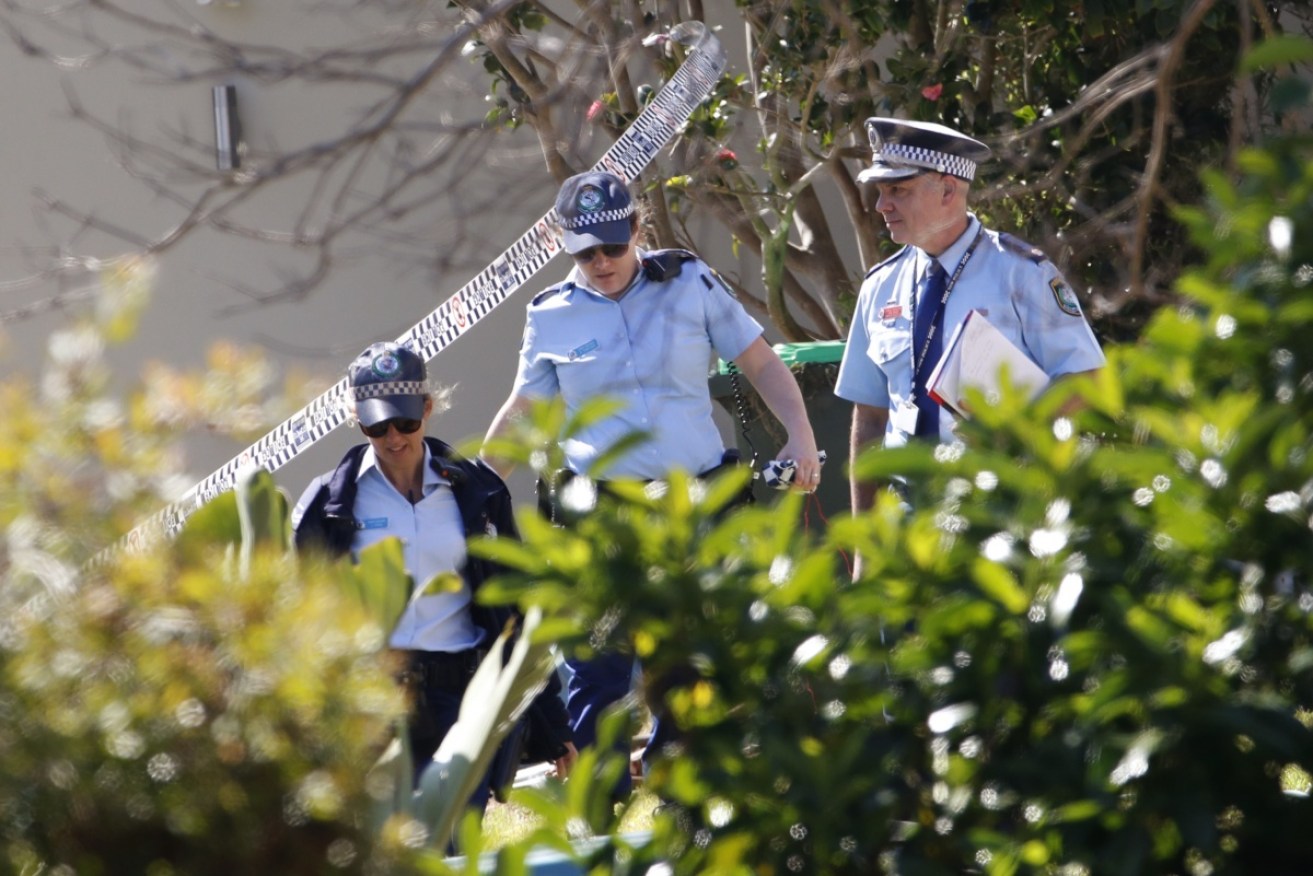 Police are pictured at the scene after a woman, 50, was found dead at an Avalon home.
