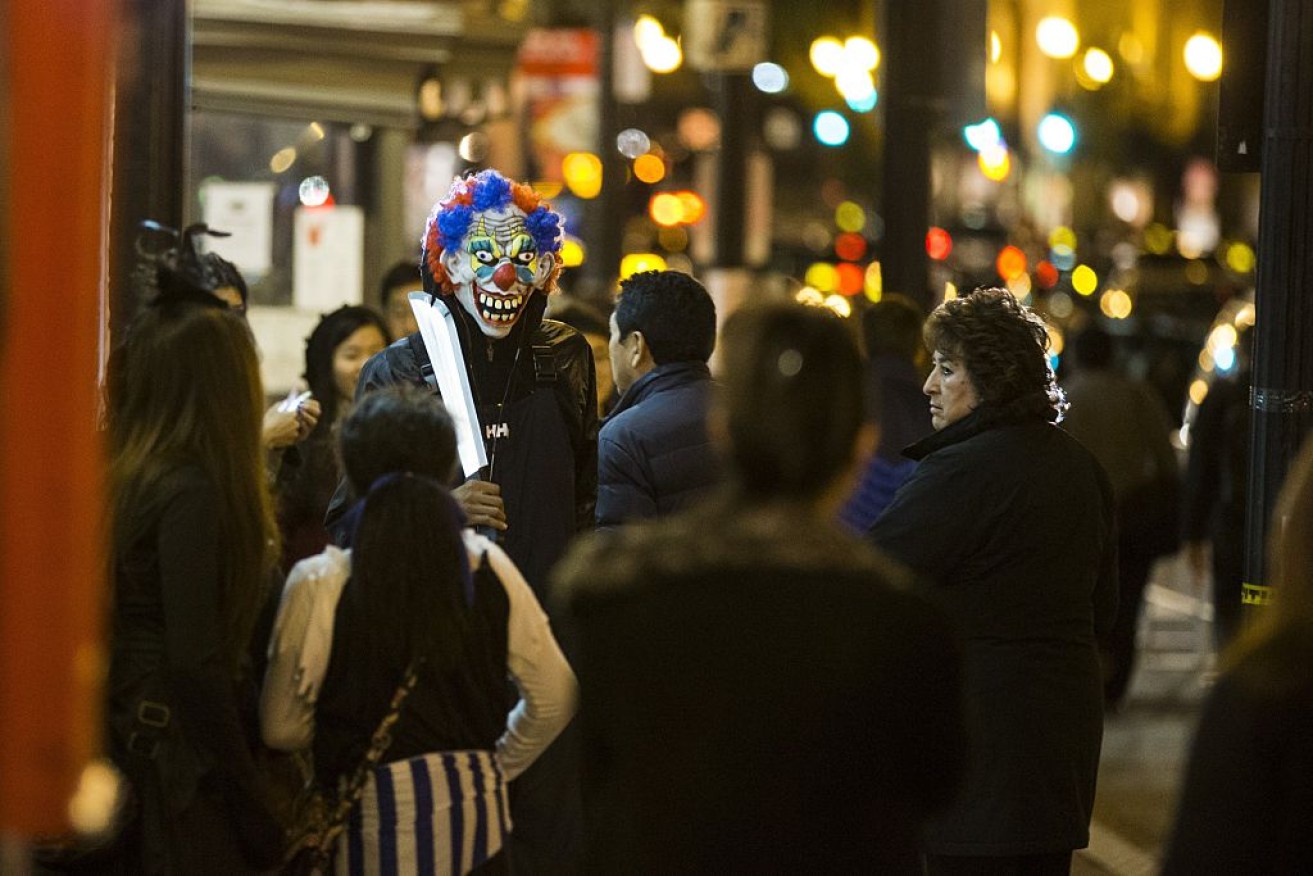 A man is pictured dressed as a creepy clown in Washington on Halloween last year.