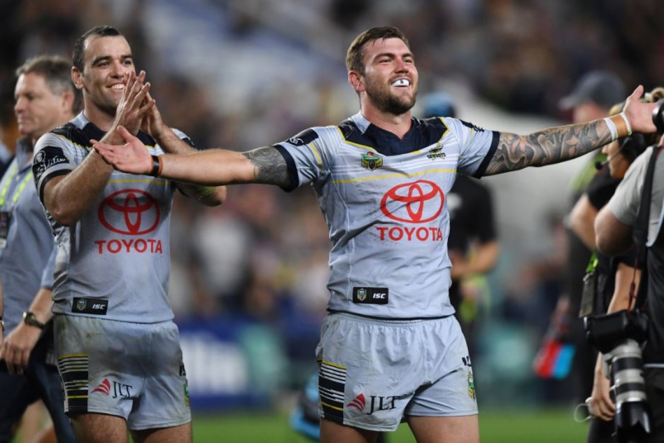 Kyle Feldt (right) and Kane Linnett of the Cowboys gesture to the crowd as they celebrate winning the NRL Preliminary Final between the Sydney Roosters and North Queensland Cowboys at the Allianz Stadium in Sydney.