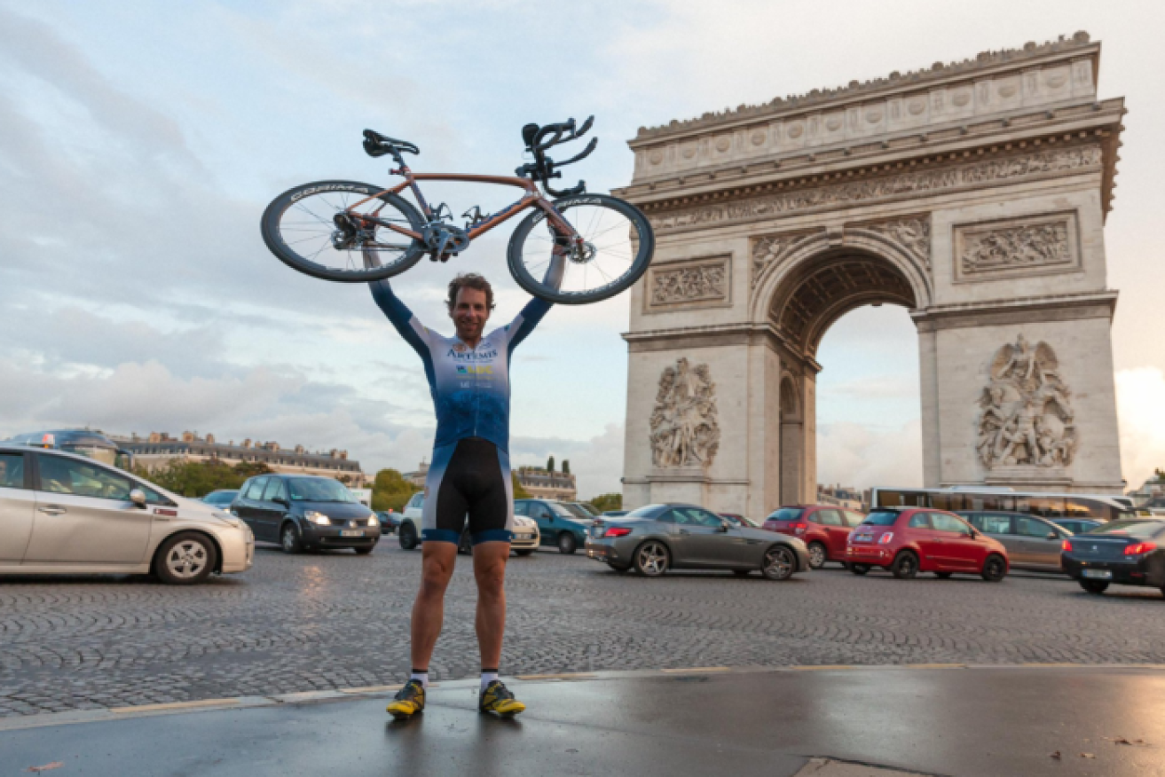 Mark Beaumont poses with his bike in France after completing his circumnavigation of the globe in under 80 days. 