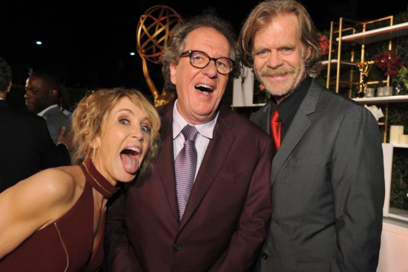 Geoffrey Rush (centre) laughs it up at a pre-Emmys bash with <i> Desperate Housewives</i>' Felicity Huffman and her real-life hubby, William H. Macy.