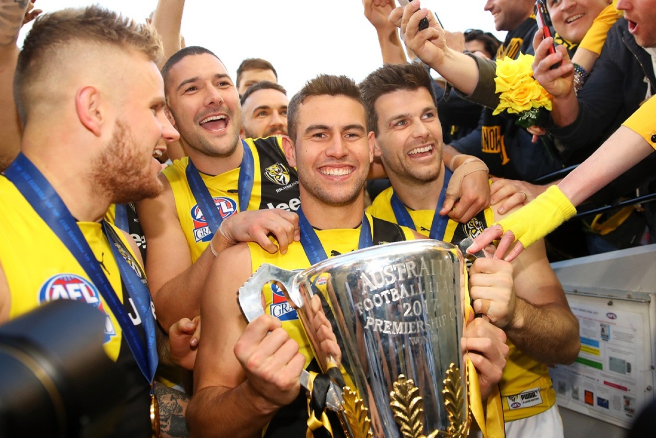 Graham and Richmond captain Trent Cotchin hold the premiership cup.