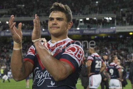 Online trolls charged with racially abusing NRL star Latrell Mitchell