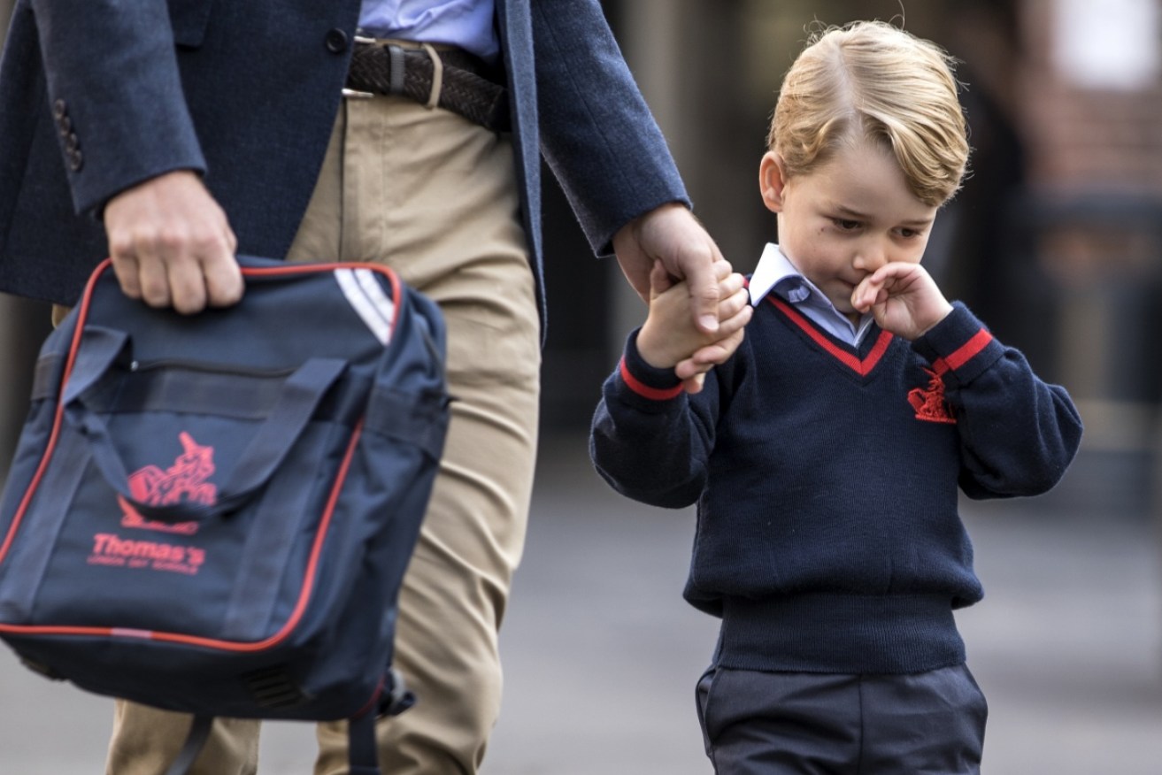 Big day: Prince George  and his new bag, held by Dad, on his first day at school.