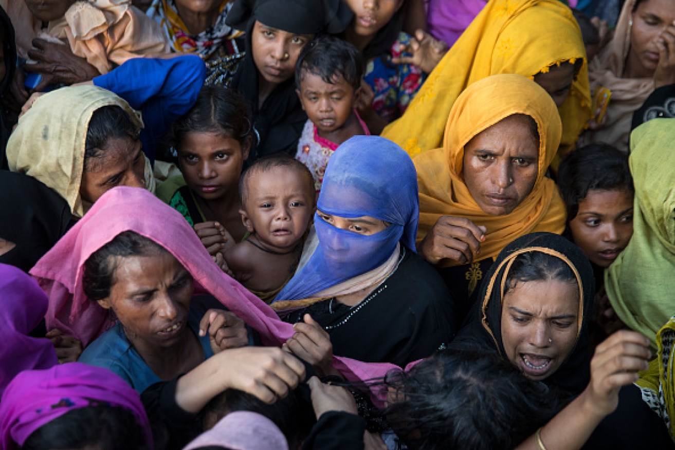Desperate Rohingya grab for aid handouts of clothing and food on Friday in Tankhali, Bangladesh as more than 400,000 Rohingya have fled into Bangladesh since late August. Photo: Paula Bronstein/Getty