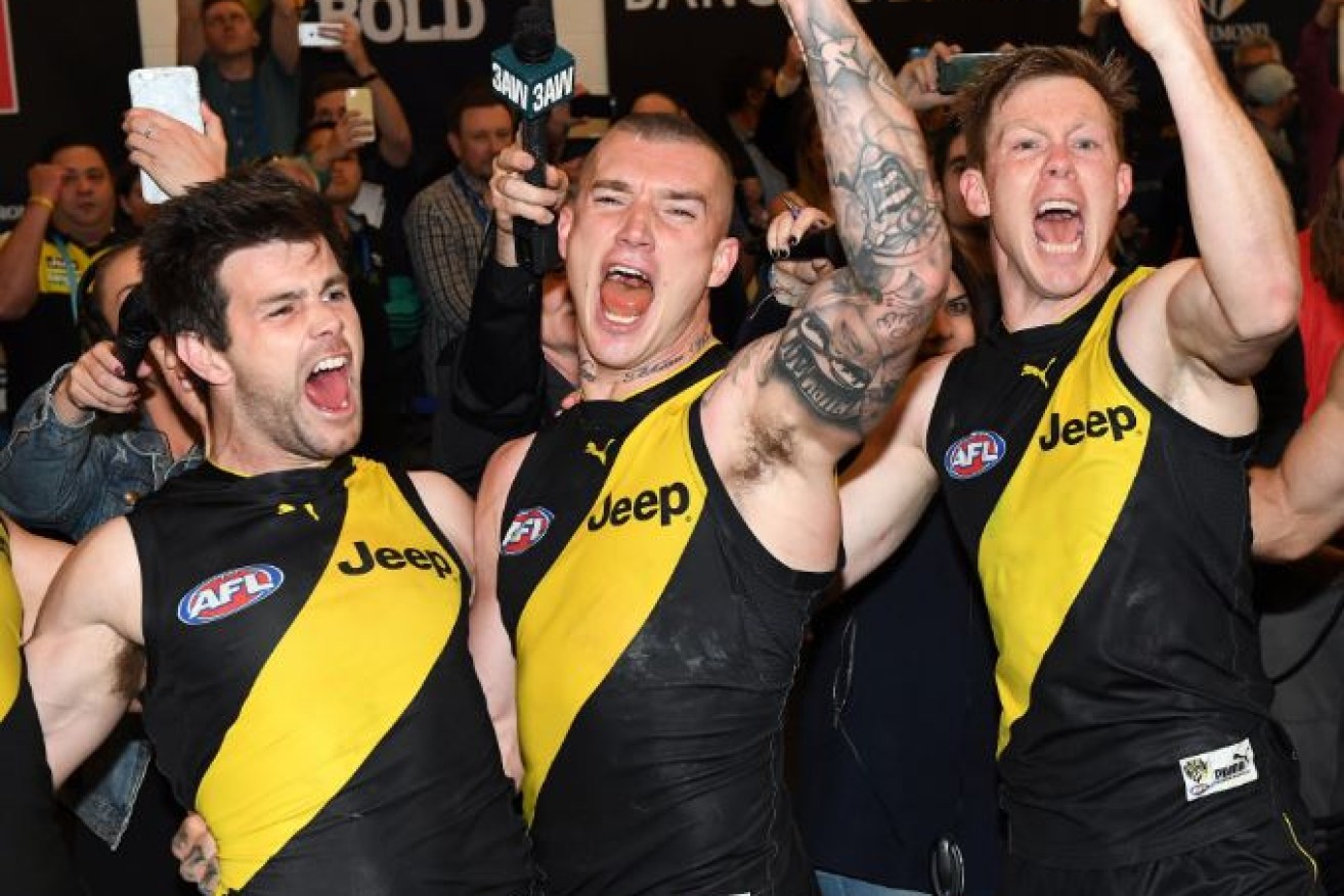 Trent Cotchin, Dustin Martin and Jack Riewoldt of the Tigers react after winning the second AFL preliminary final between the Richmond Tigers and the GWS Giants at MCG.