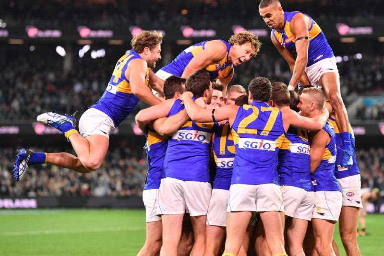 Eagles players react after their last-gasp win over  Port Adelaide Power.