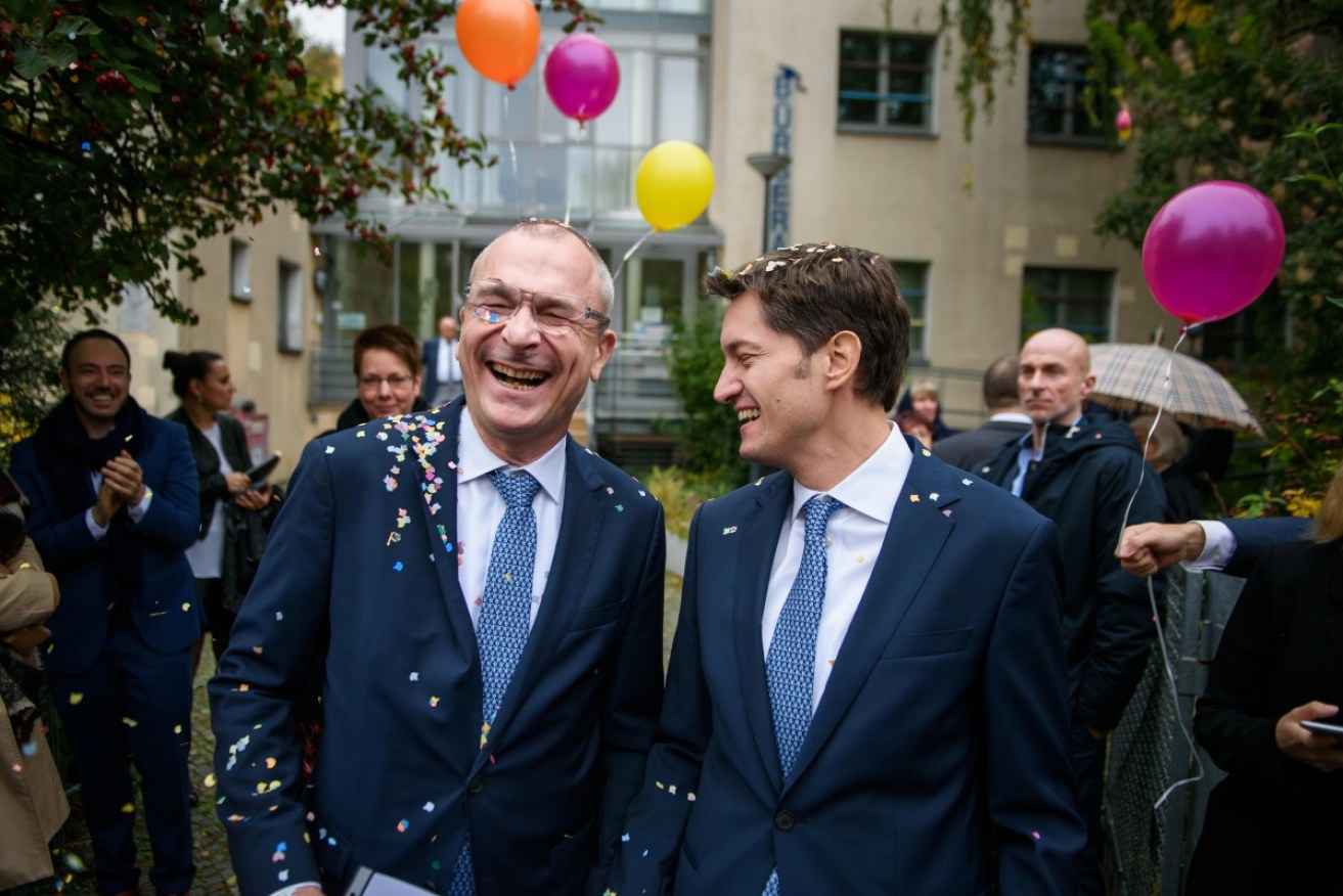 Volker Beck and his spouse Adrian Petkov are received by friends and family with confetti and balloons after getting married in Berlin.
