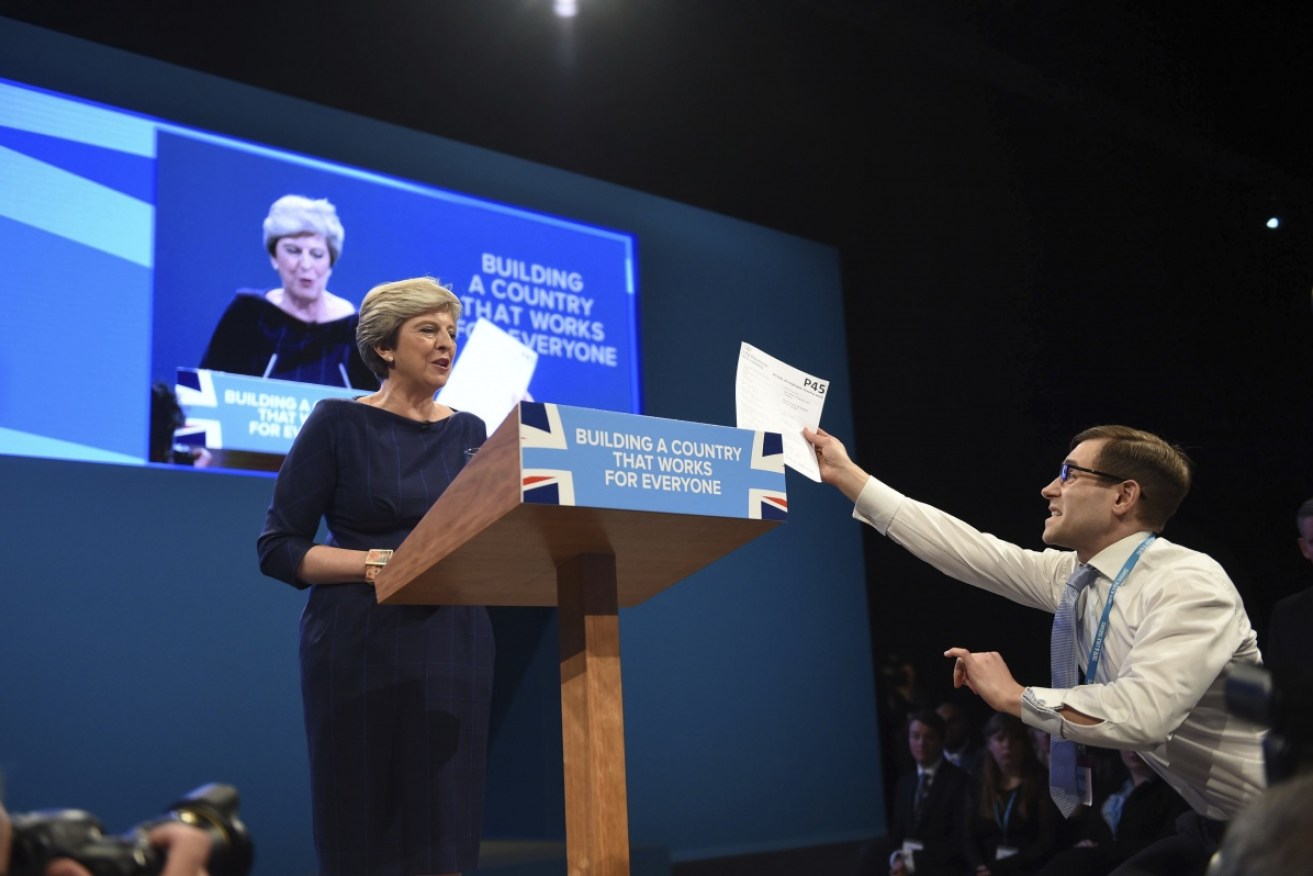 Comedian Simon Brodkin confronts British PM Theresa May during her Conservative Party Conference speech.