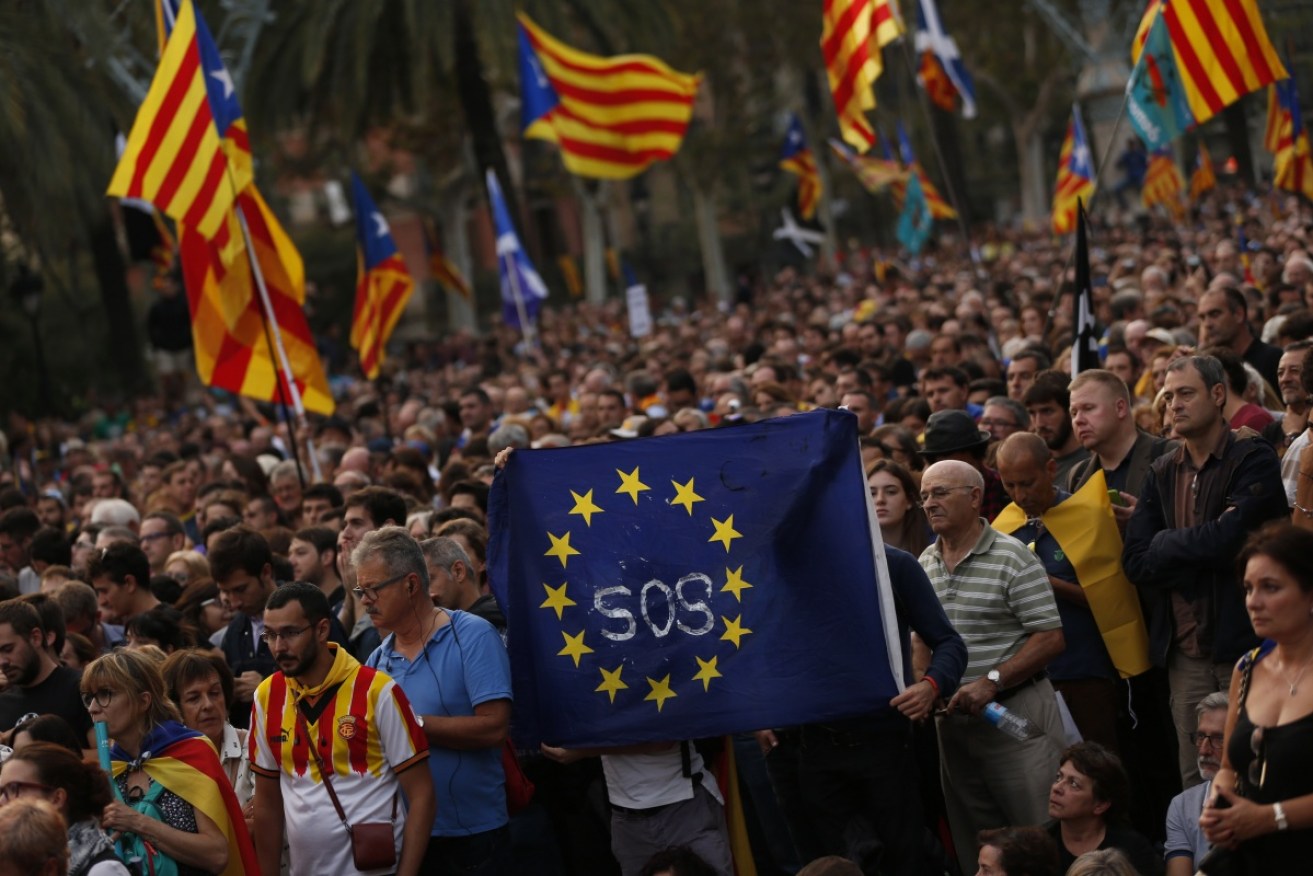 Pro-independence supporters hold a European Union flag during a rally in Barcelona, Spain on October 10.