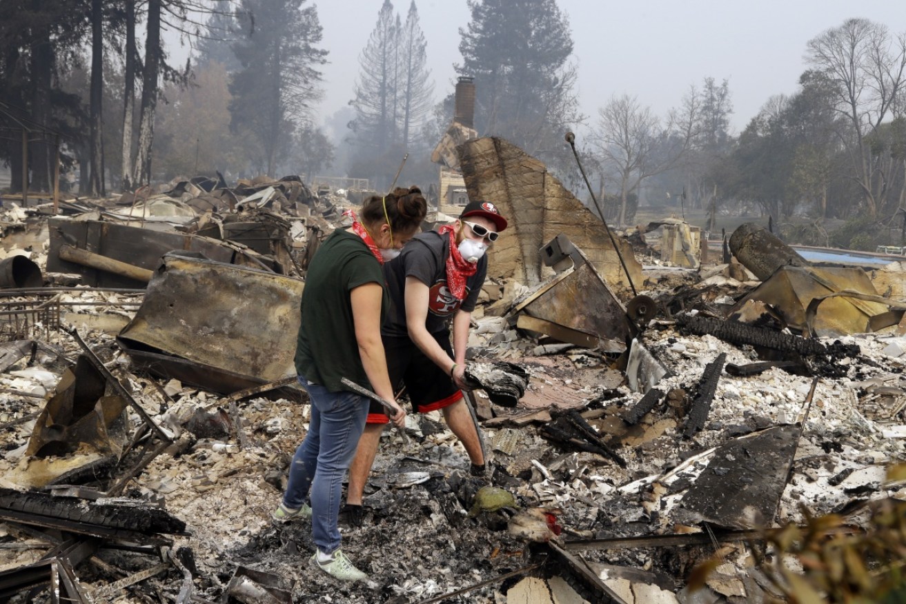 Robyn and Daniel Pellegrini search for belongings in the ashes of their home that was destroyed by fire in the Coffey Park area of Santa Rosa, California.
