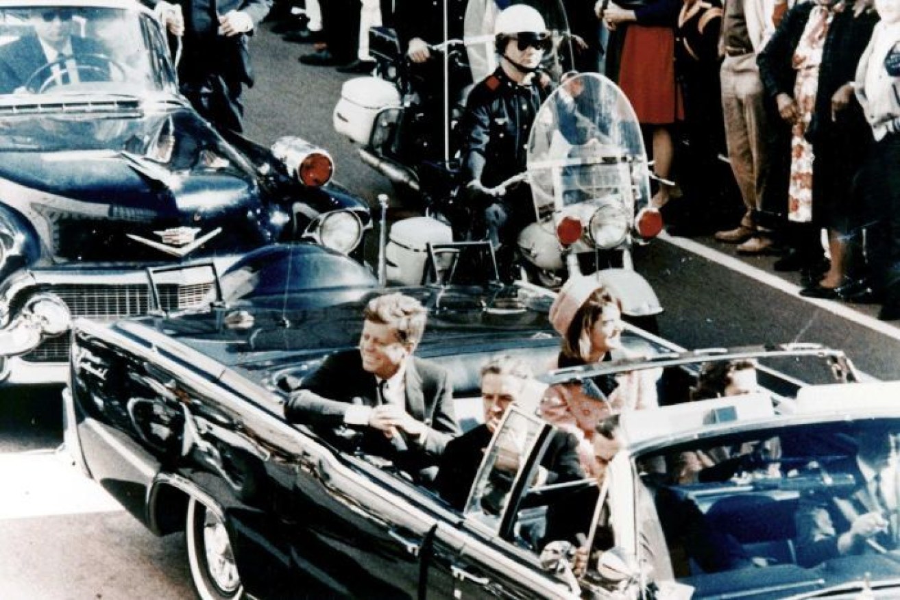 John F Kennedy and his wife Jackie in the limousine as it makes its way through Dallas.