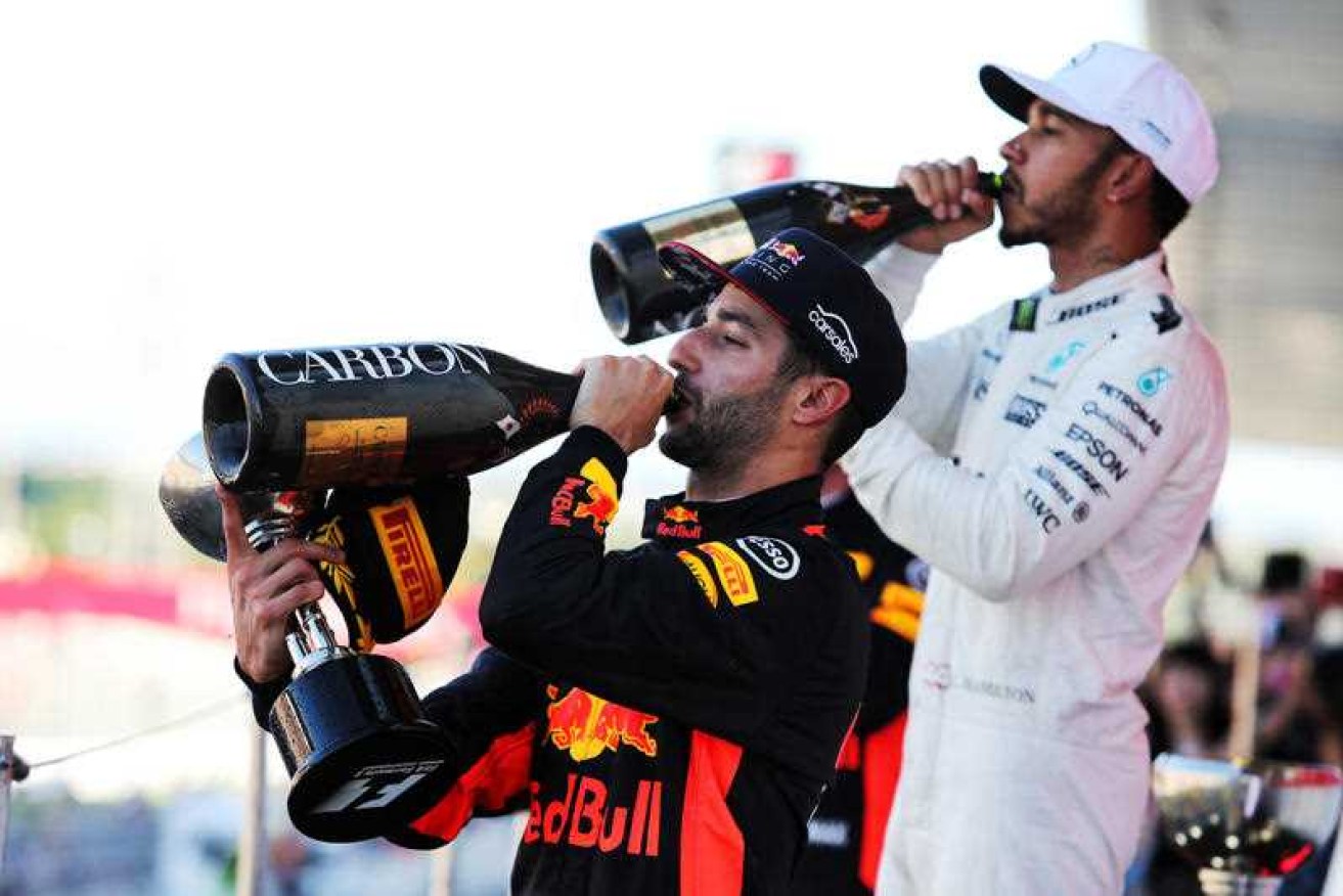 Daniel Ricciardo celebrates on the podium with Lewis Hamilton.