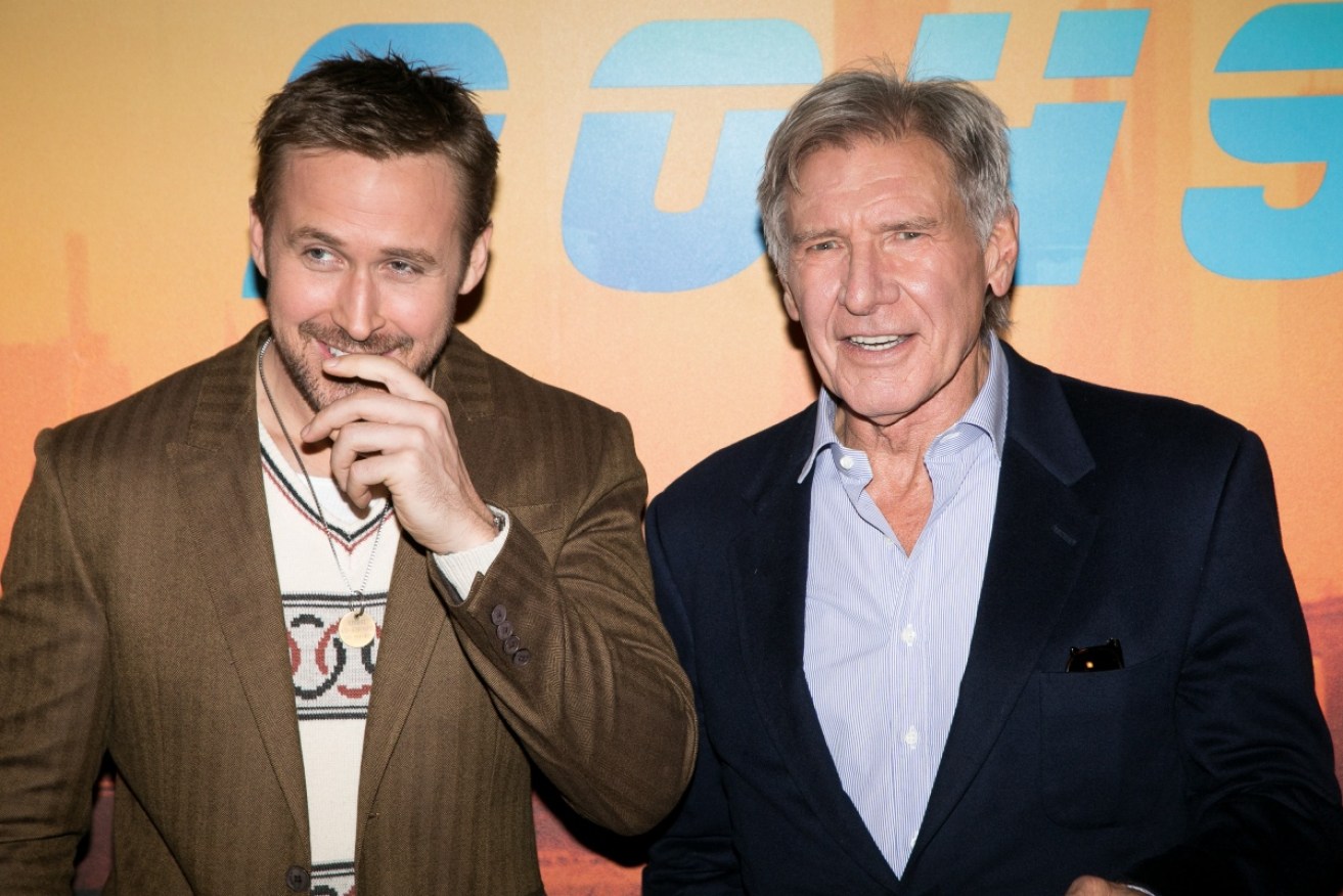 You're forgiven: Ryan Gosling yucked it up with Harrison Ford in Paris on Sept. 20.