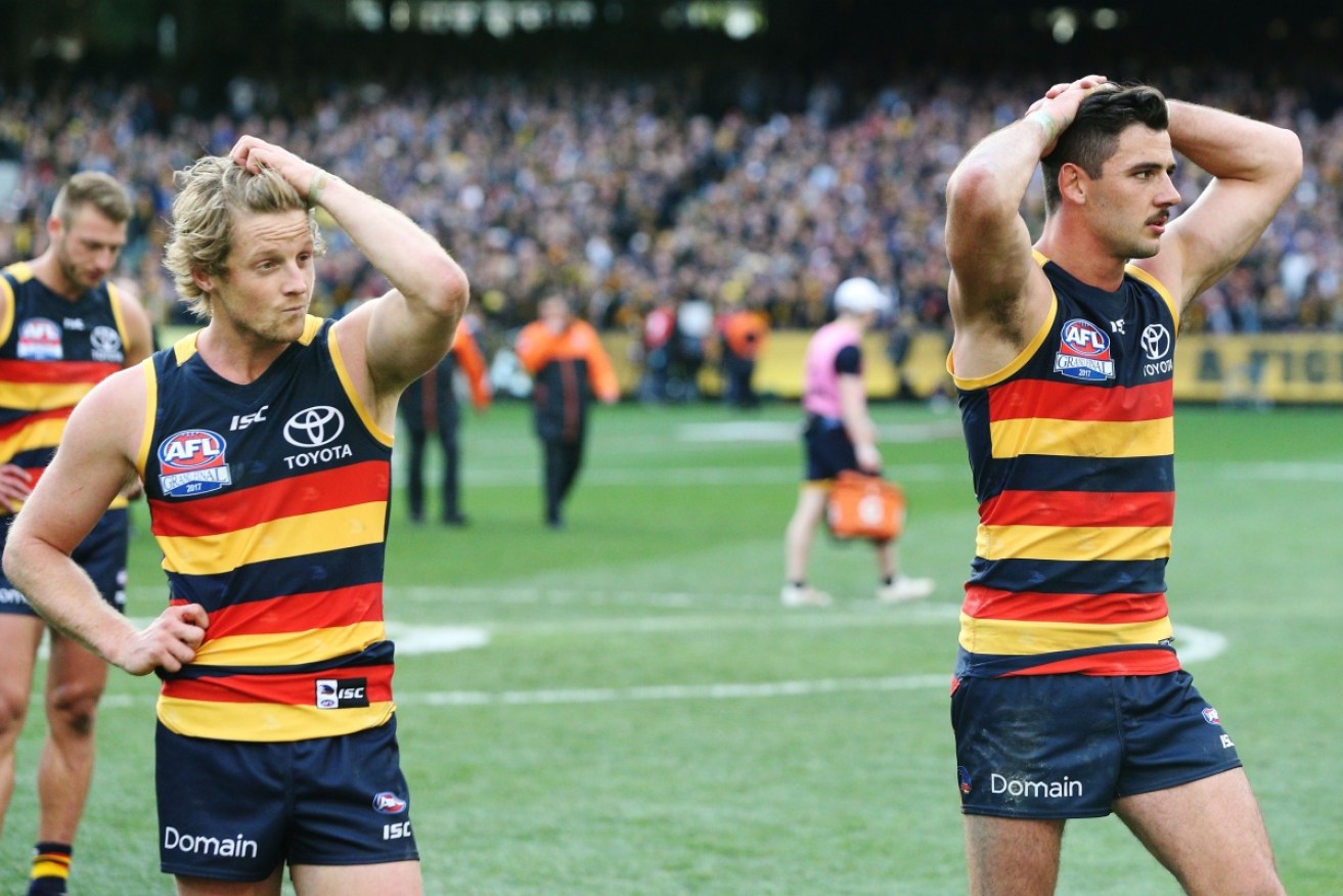 Defeated: Adelaide's Rory Sloane (L) and Taylor Walker after the siren on grand final day. 