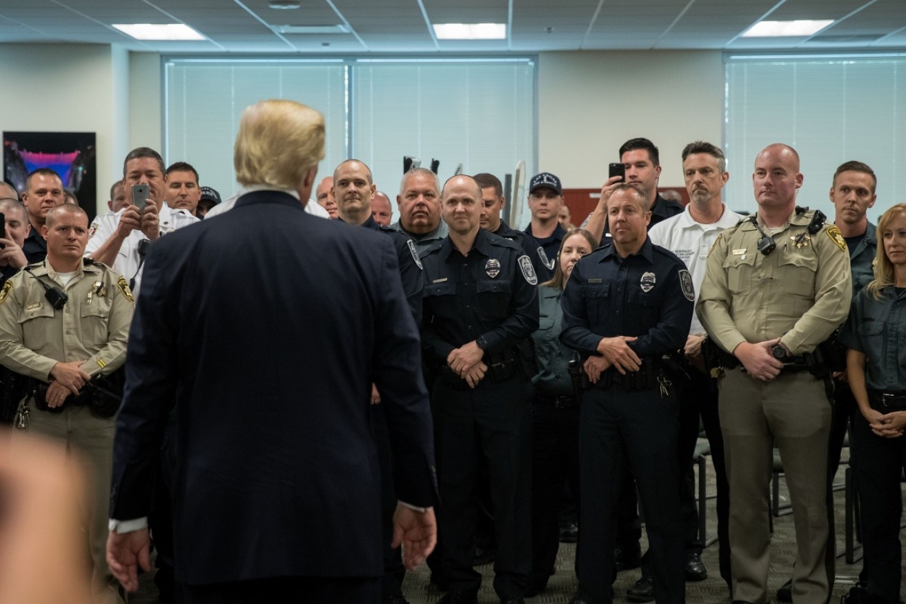 President Donald Trump greets a room full of police officers and first responders at Las Vegas Metropolitan Police Department headquarters.