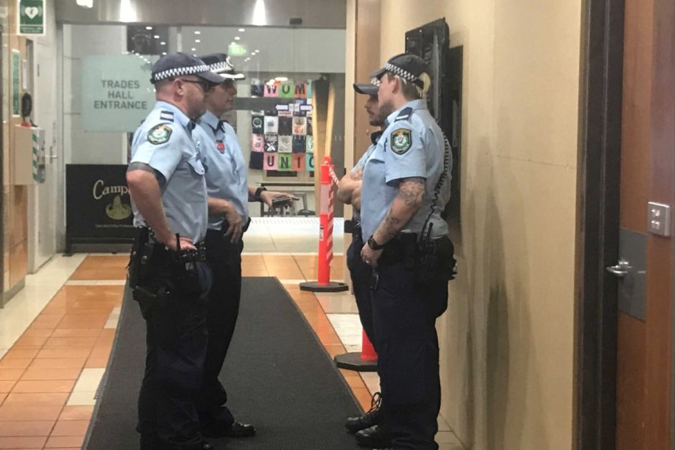 Police outside the offices of the Australian Workers' Union on the day of the raids.