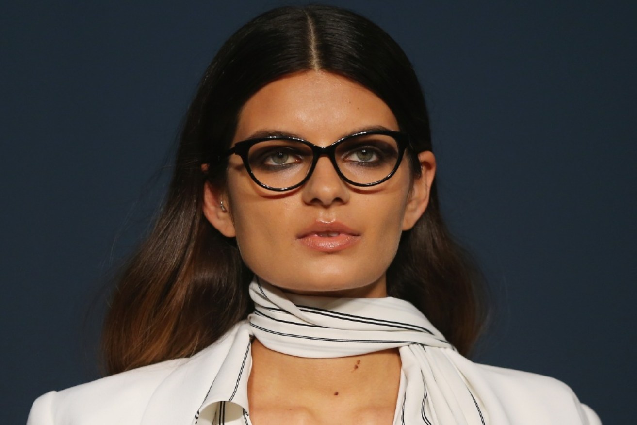 A model struts the runway at the Carla Zampatti for Specsavers show in a flattering cat's eye frame.