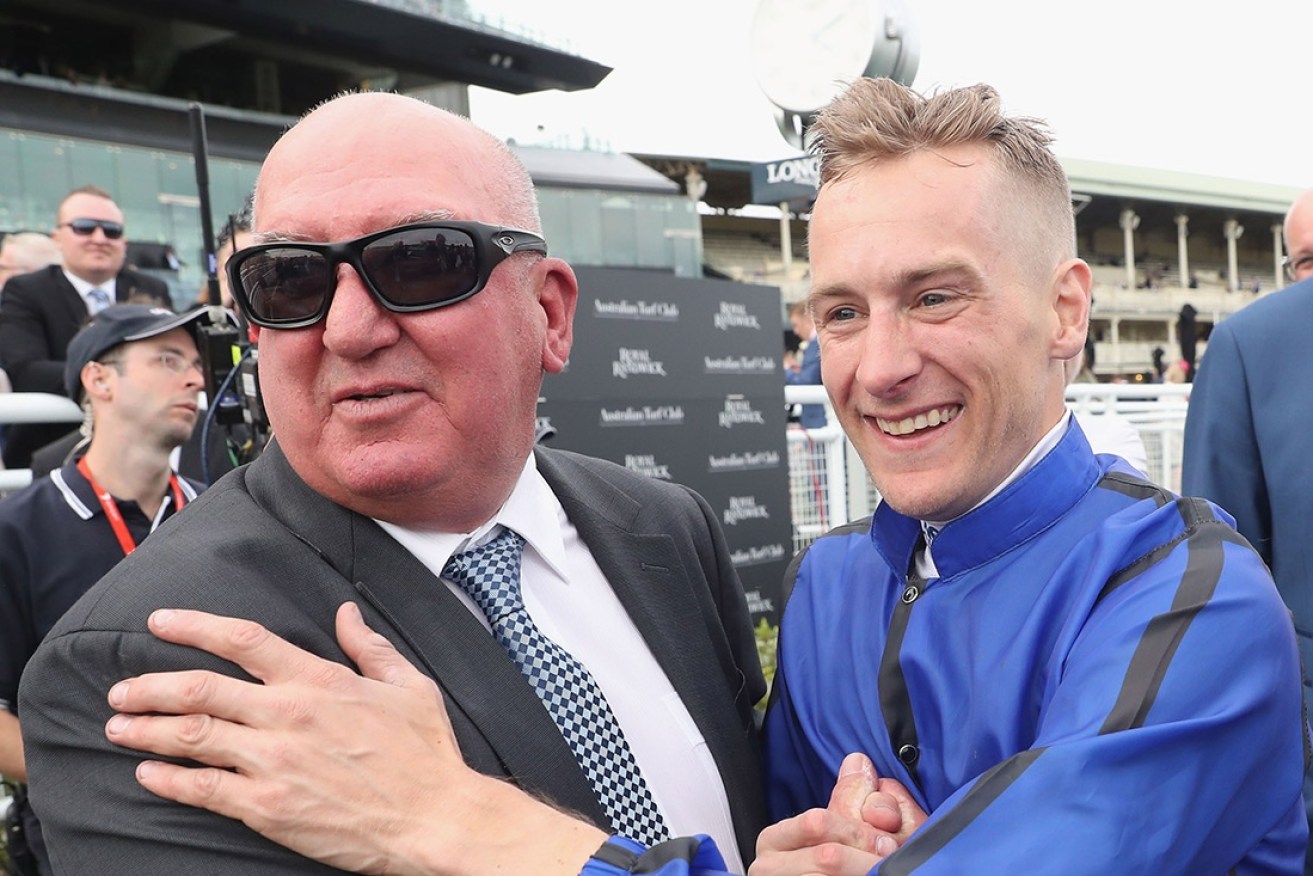 Pat Webster and jockey Blake Shinn embrace after winning the Epsom Handicap with Happy Clapper in September.