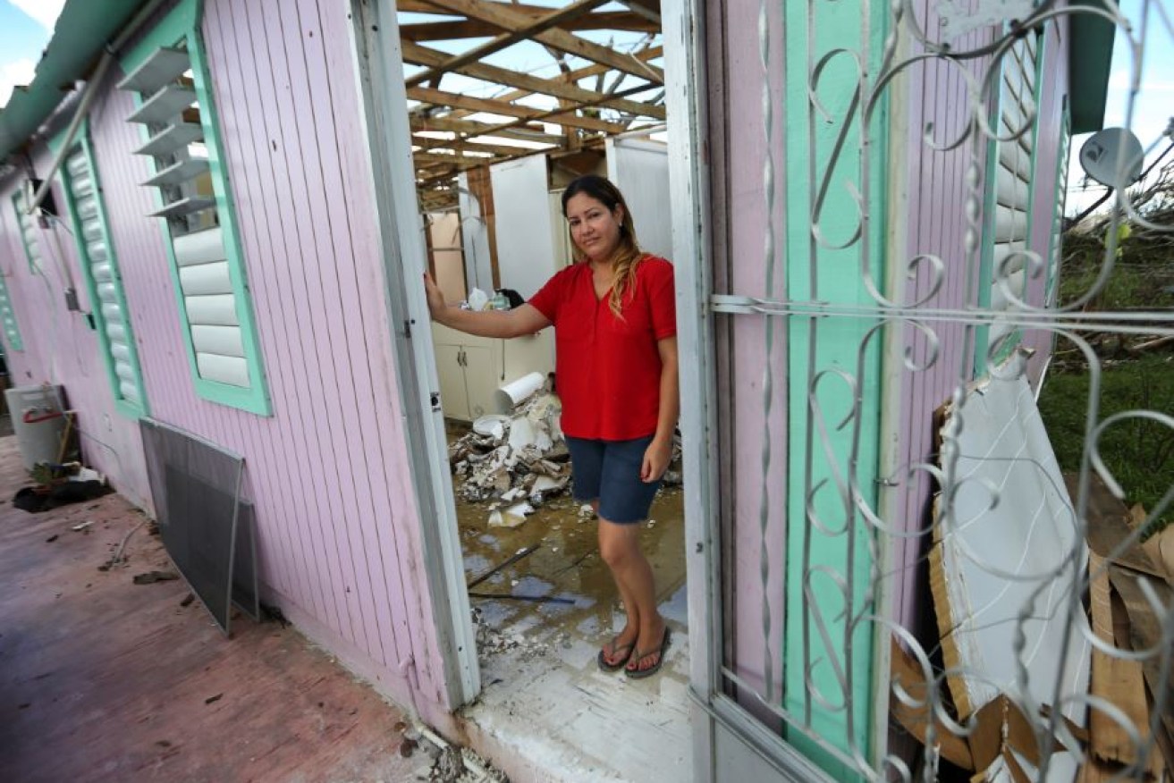 Mum Sandy Nieves waits for aid to arrive in the wreckage of her family home, utterly destroyed by Hurricane Maria.