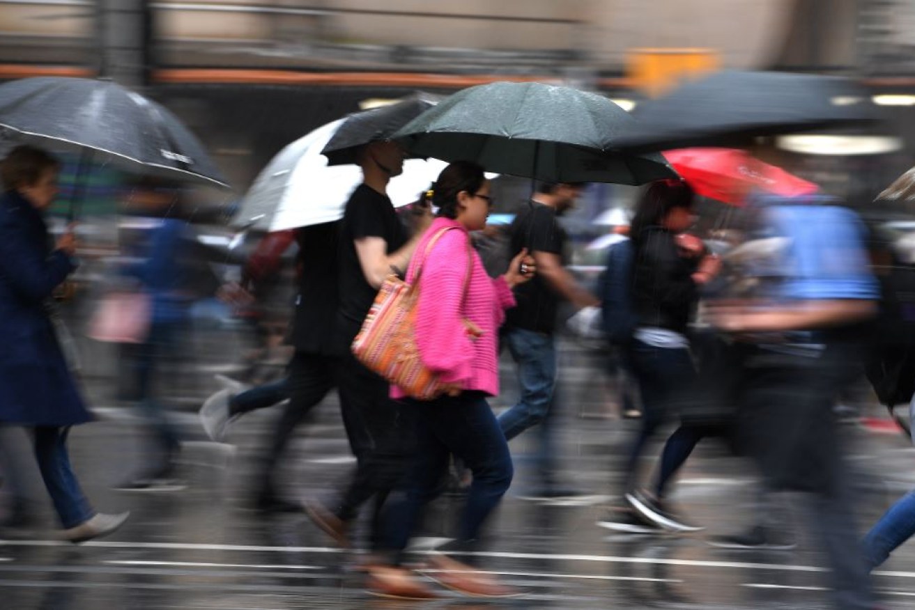 Pedestrians scurry for shelter in Sydney's CBD as the skies opened and plunged traffic into a state of stalled and soggy chaos.