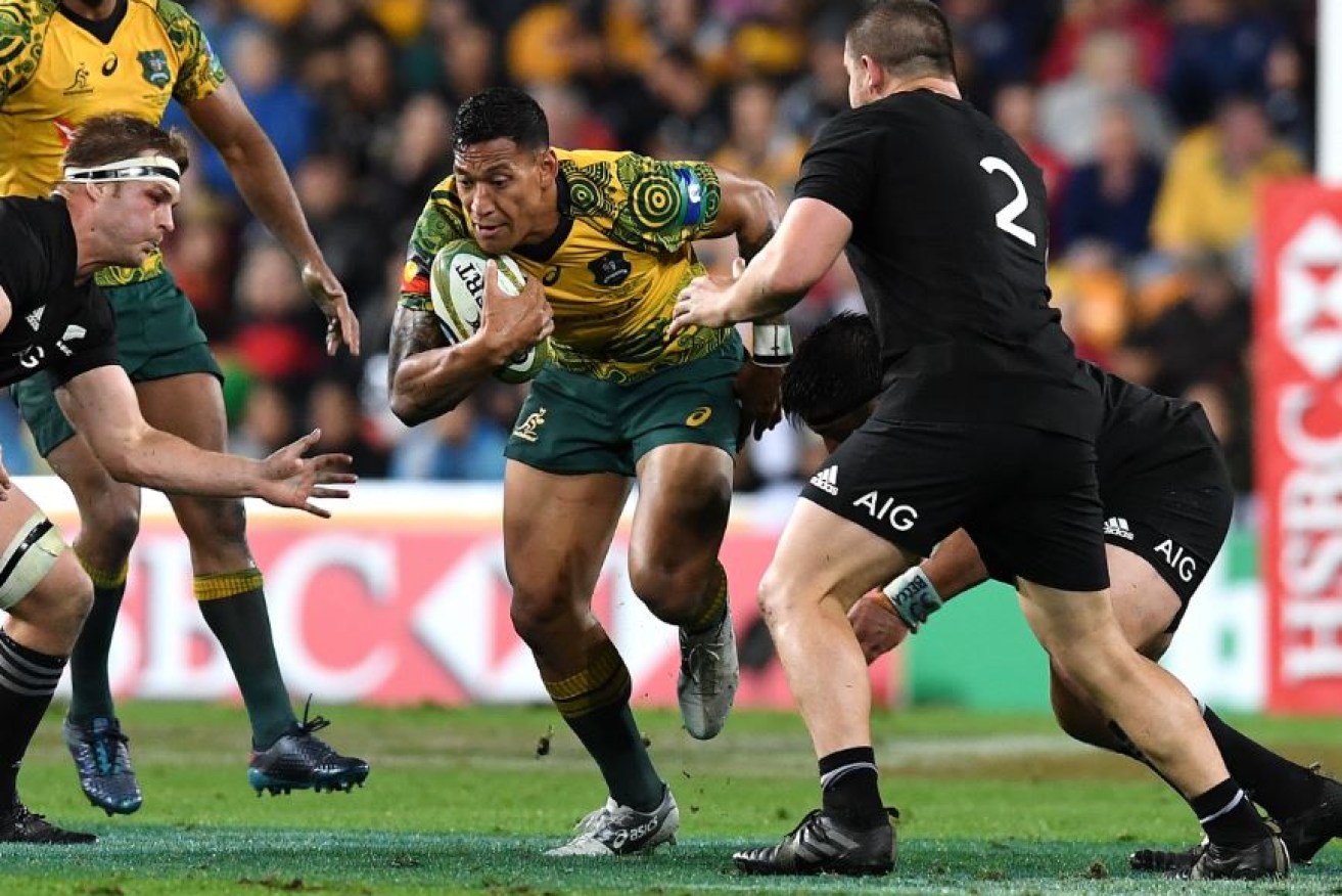 Nothing is stopping Israel Folau as he powers through a wall of All Blacks on his way to the try line.
