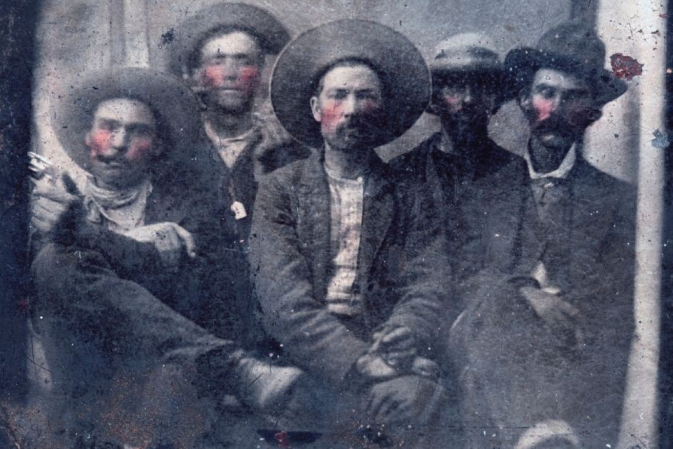 Historians believe the tintype photo of outlaw Billy the Kid, second from left, and Pat Garrett, far right, was taken in 1880.