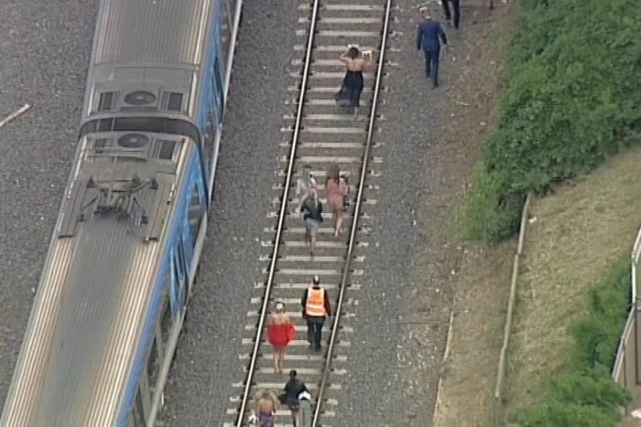 Racegoers are forced to walk along train tracks to get to the Melbourne Cup. 