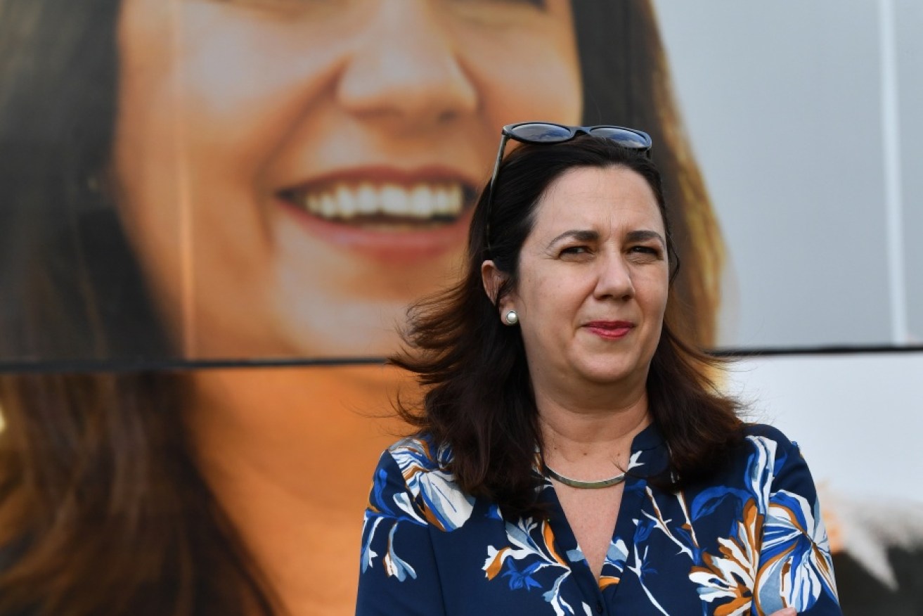 Premier Annastacia Palaszczuk is looming large in the polls as Queenslanders prepare to pick a government in Saturday's election.