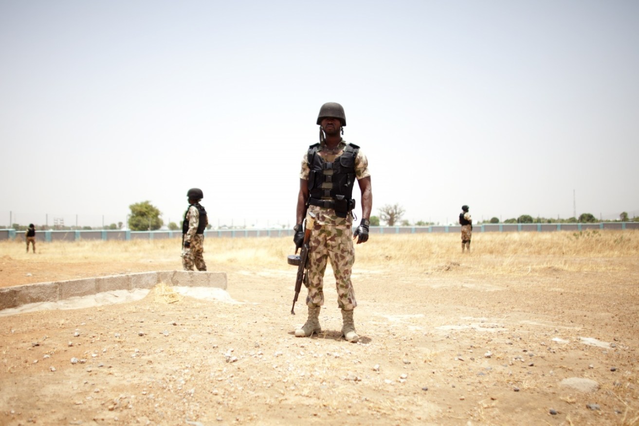 Members of the Nigerian military stand guard in Mubi, Nigeria.