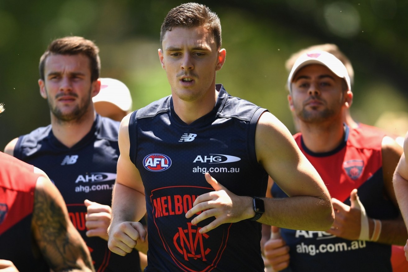 Jake Lever joins his new teammates on the training track. 