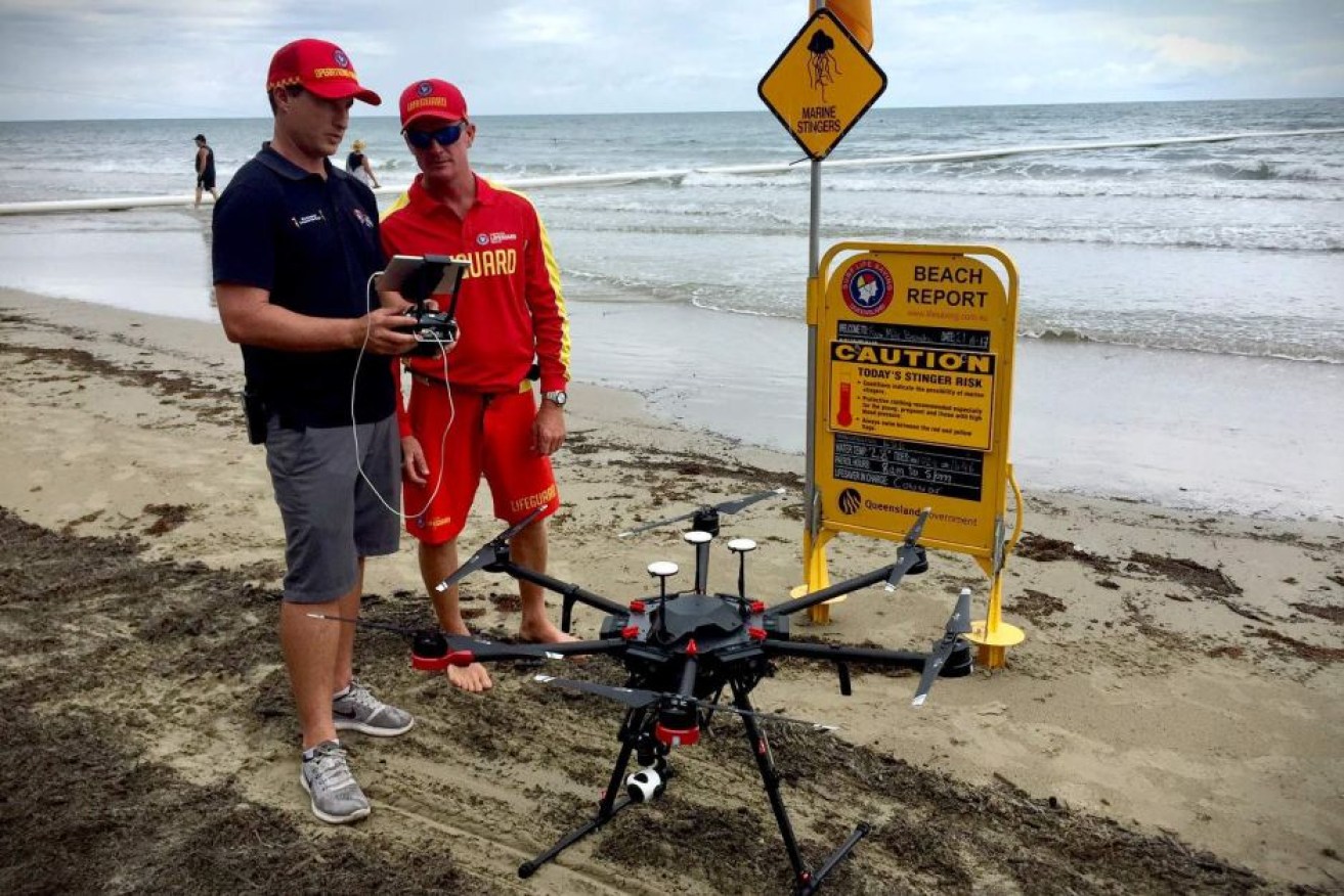 Surf Lifesaving Queensland's Tim Wilson (left) and Conor O'Sullivan inspect the new drone at Port Douglas.