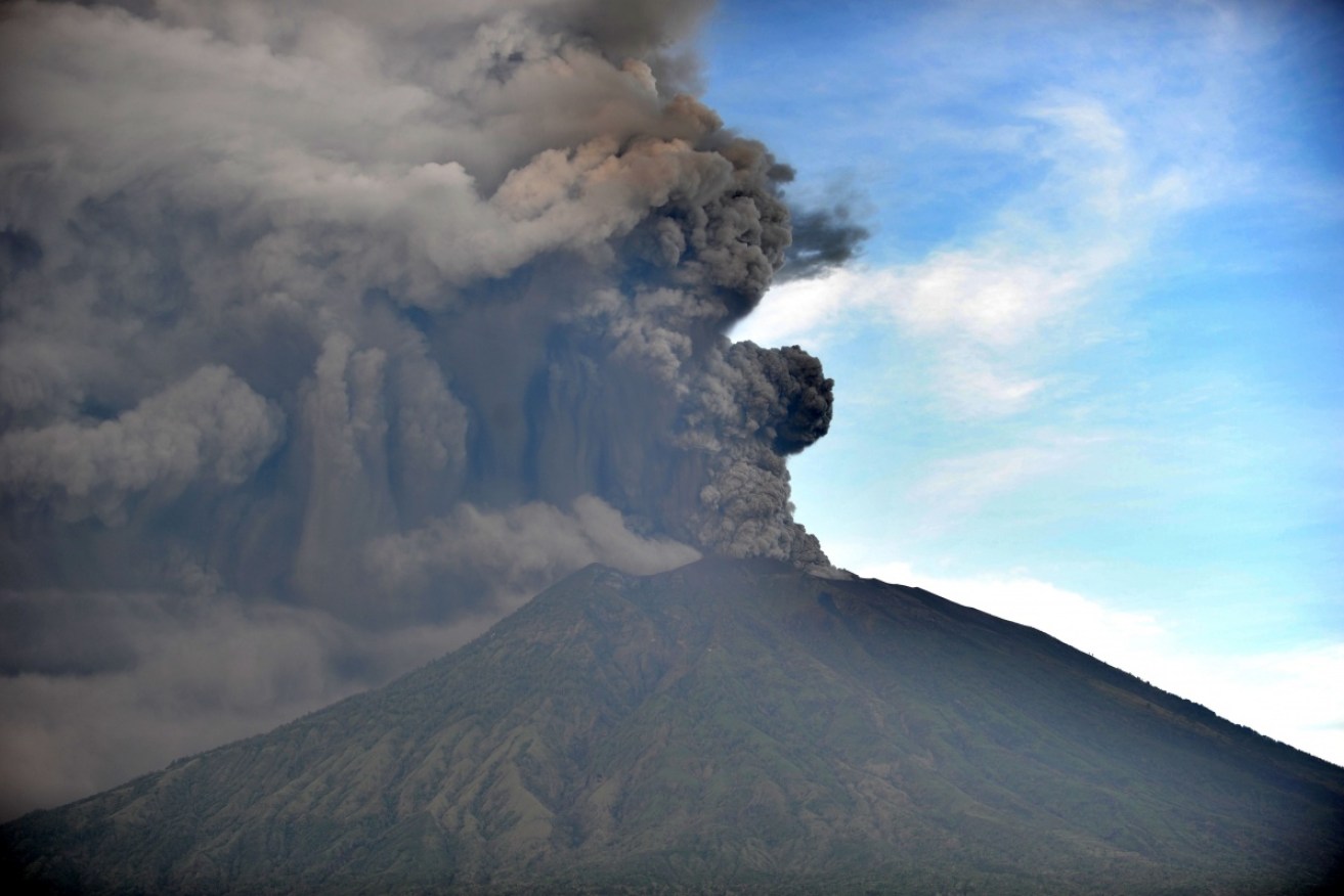 As visitors desperately try to leave Bali, thousands of villagers are refusing to evacuate the 10km danger zone arond the 3000-metre high volcano.