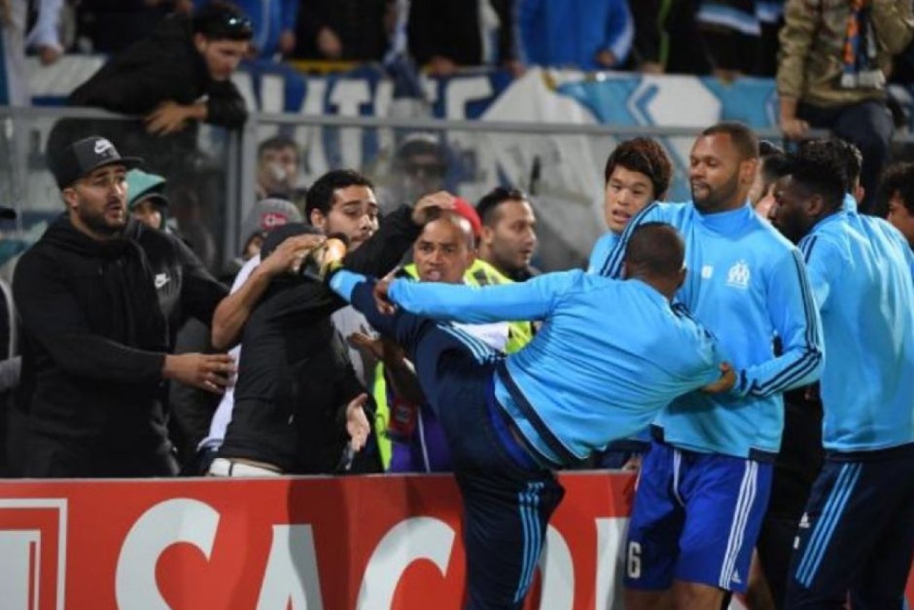Marseille defender Patrice Evra was red-carded for kicking a supporter.