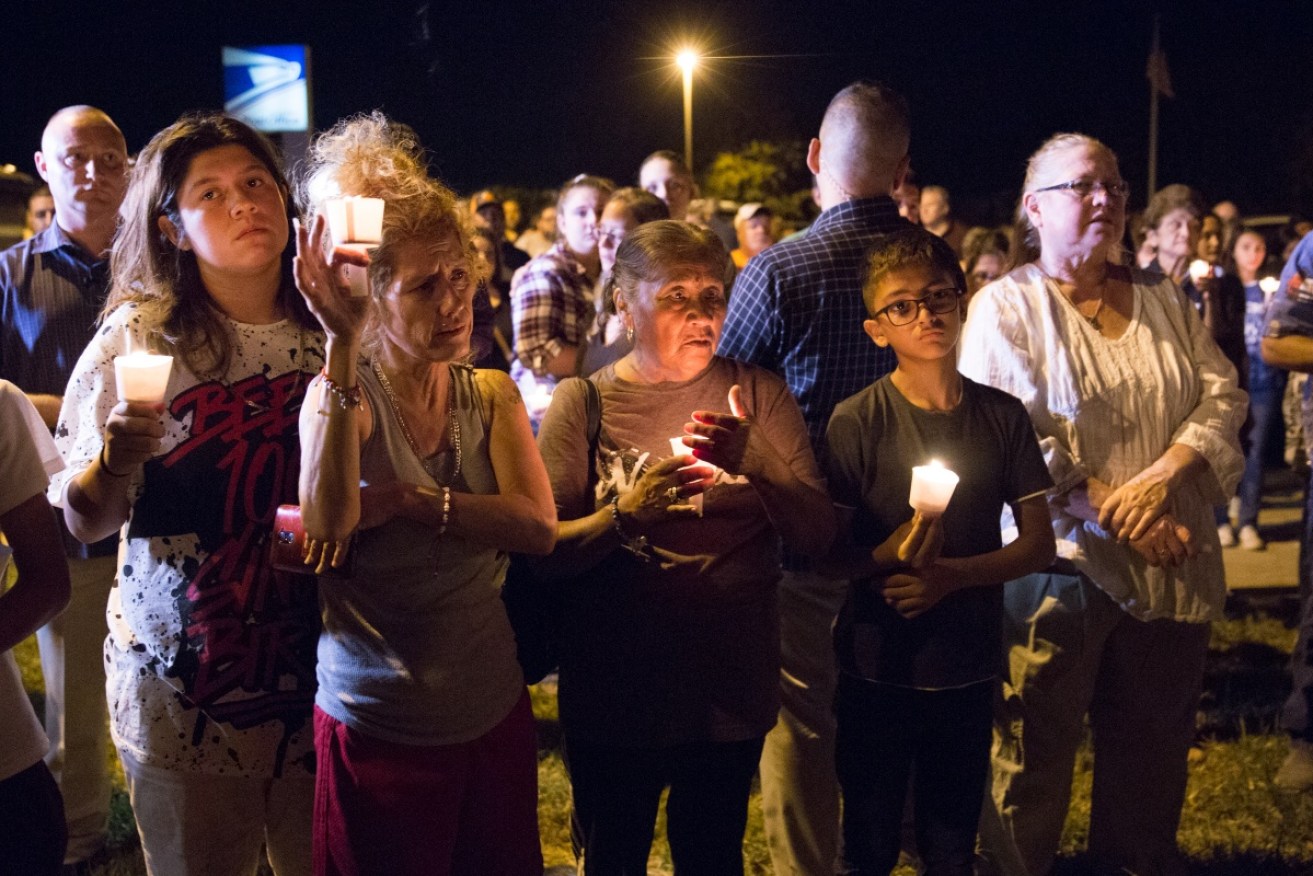 Townsfolk hold a candlelight  vigil outside the First Baptist Church in Sunderland Springswhere 26 people were shot be a lone gunman.
